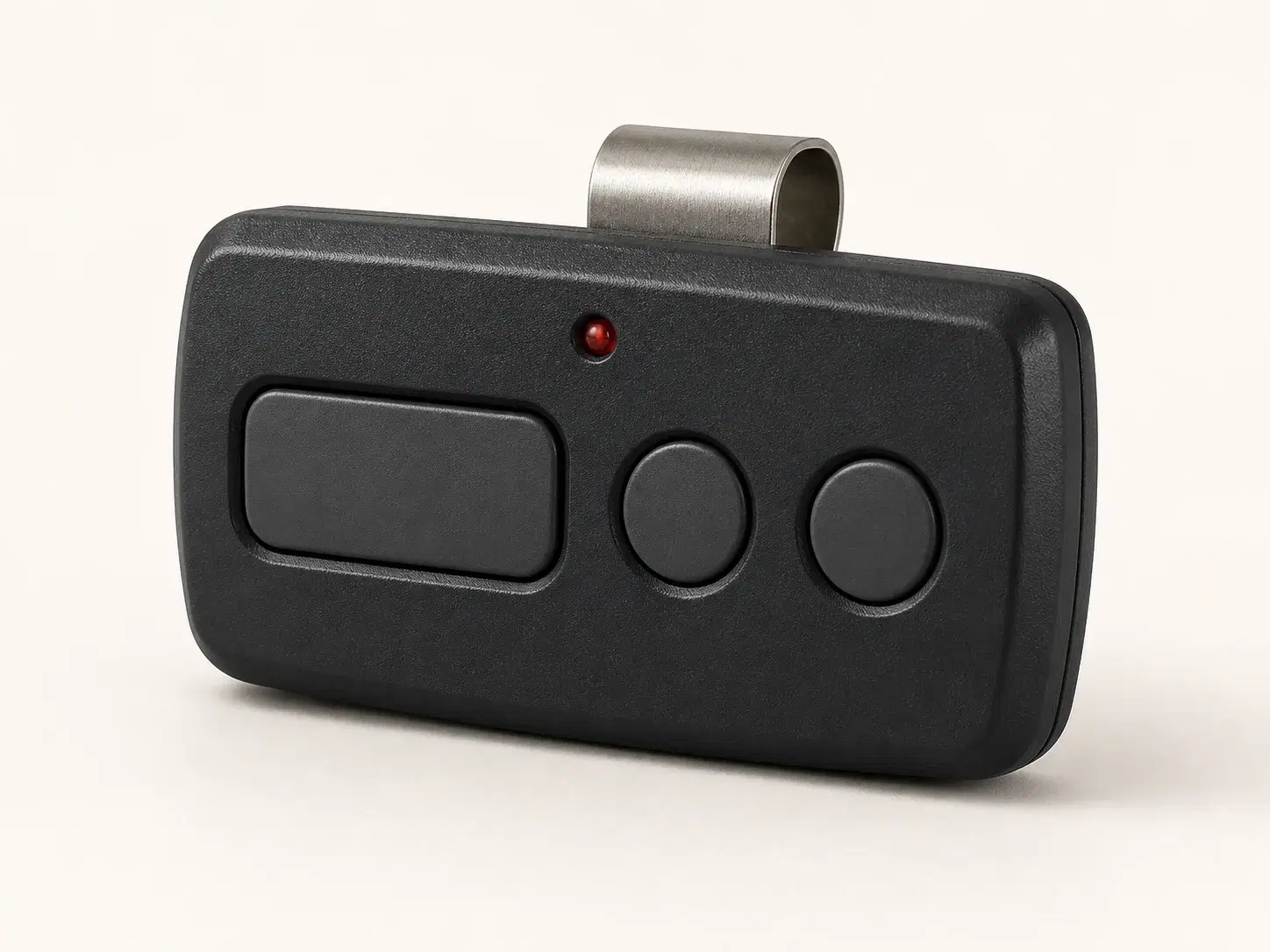 Illustrative rendering of a wide black three-button visor remote with one large and two circular buttons