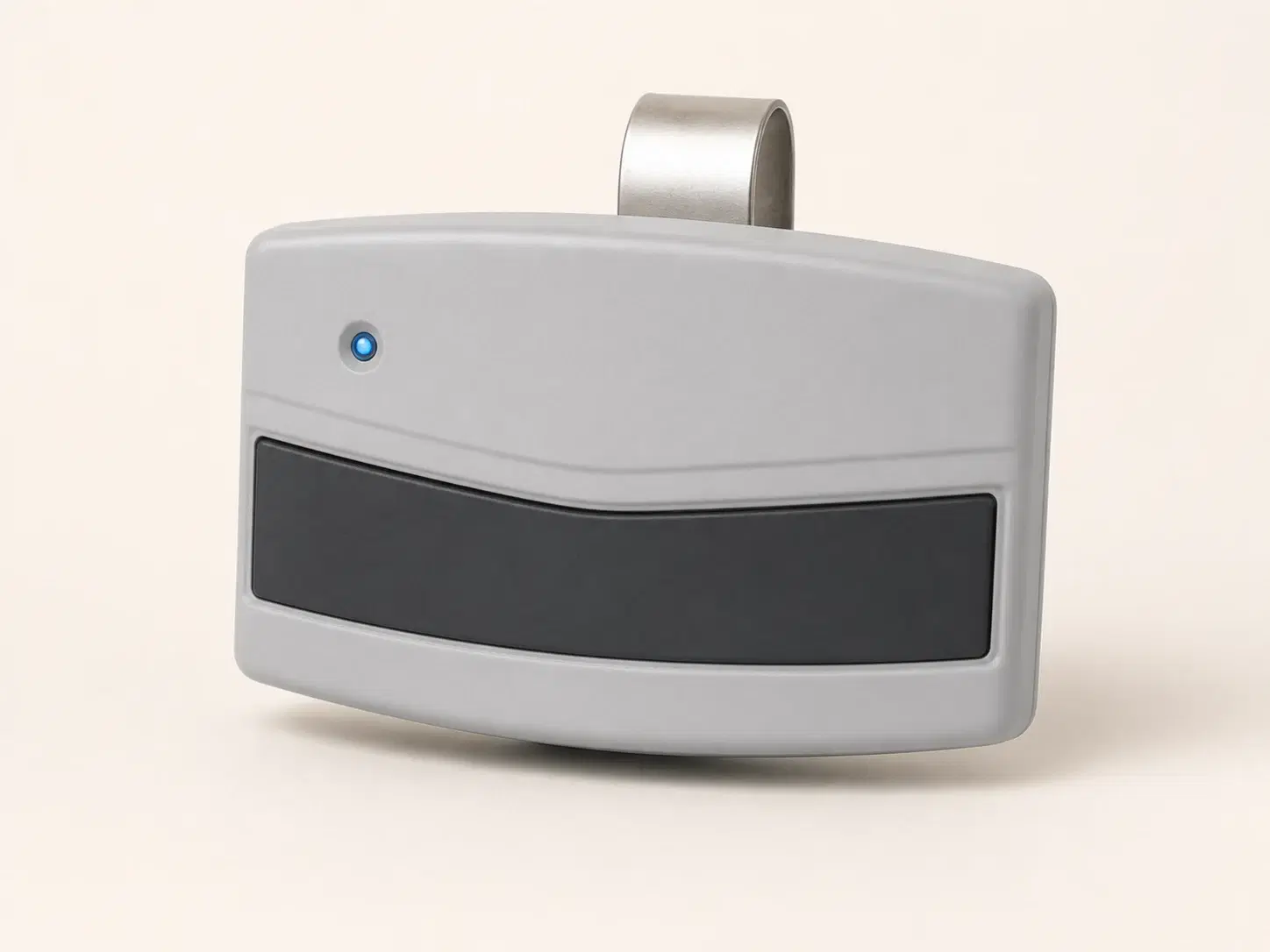 Illustrative rendering of a light gray visor remote with one wide dark button