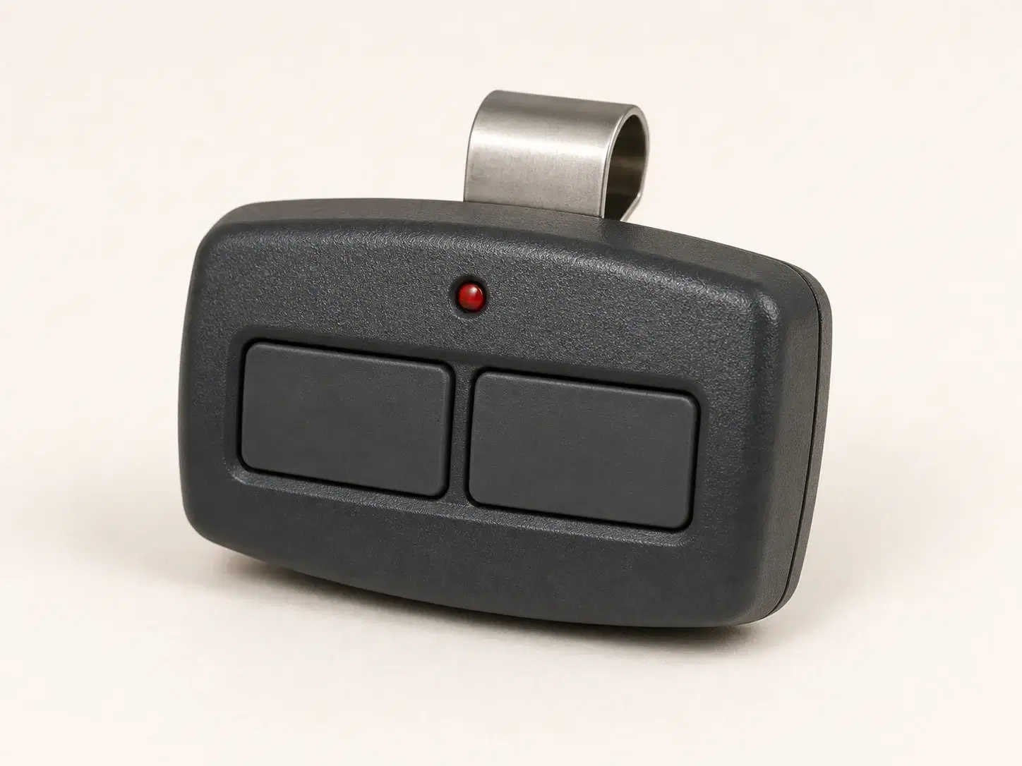 Illustrative rendering of a dark charcoal visor remote with two large horizontal buttons